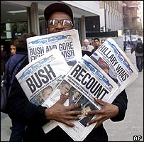 Man holding newspapers.